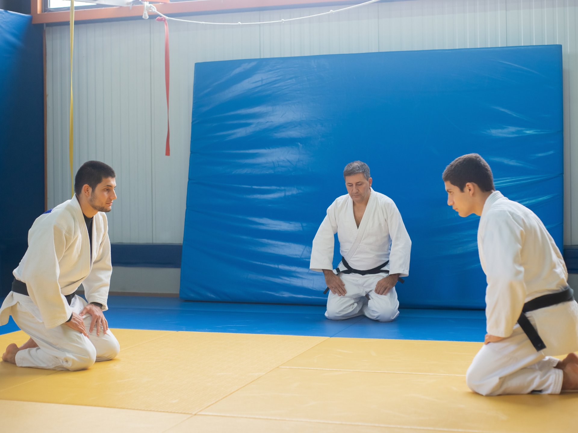 Judo instuctor training two men