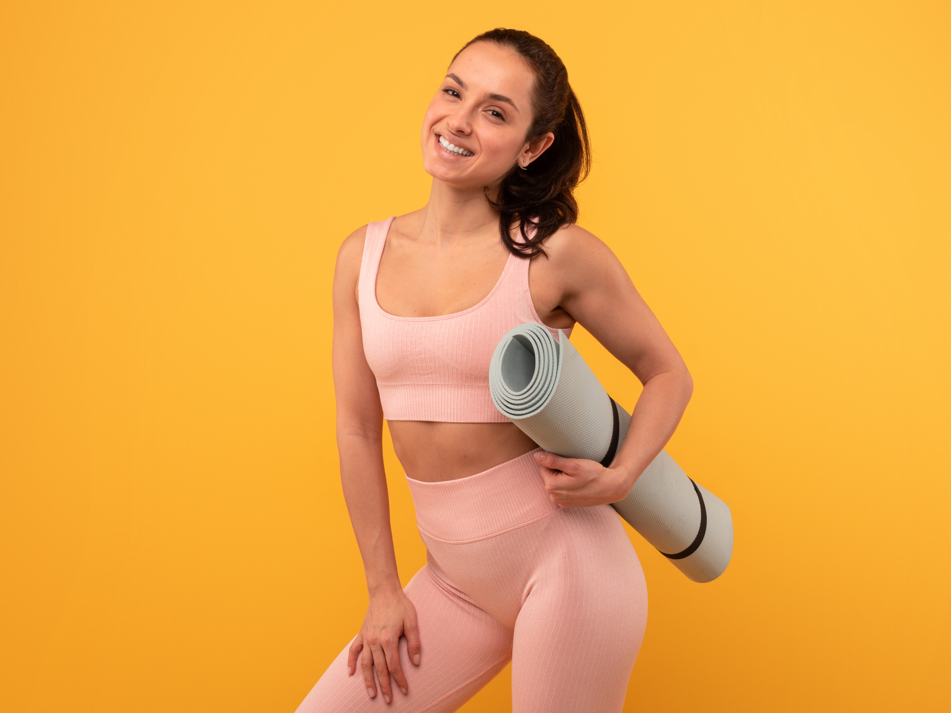smiling woman with yoga mat