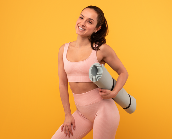smiling woman with yoga mat