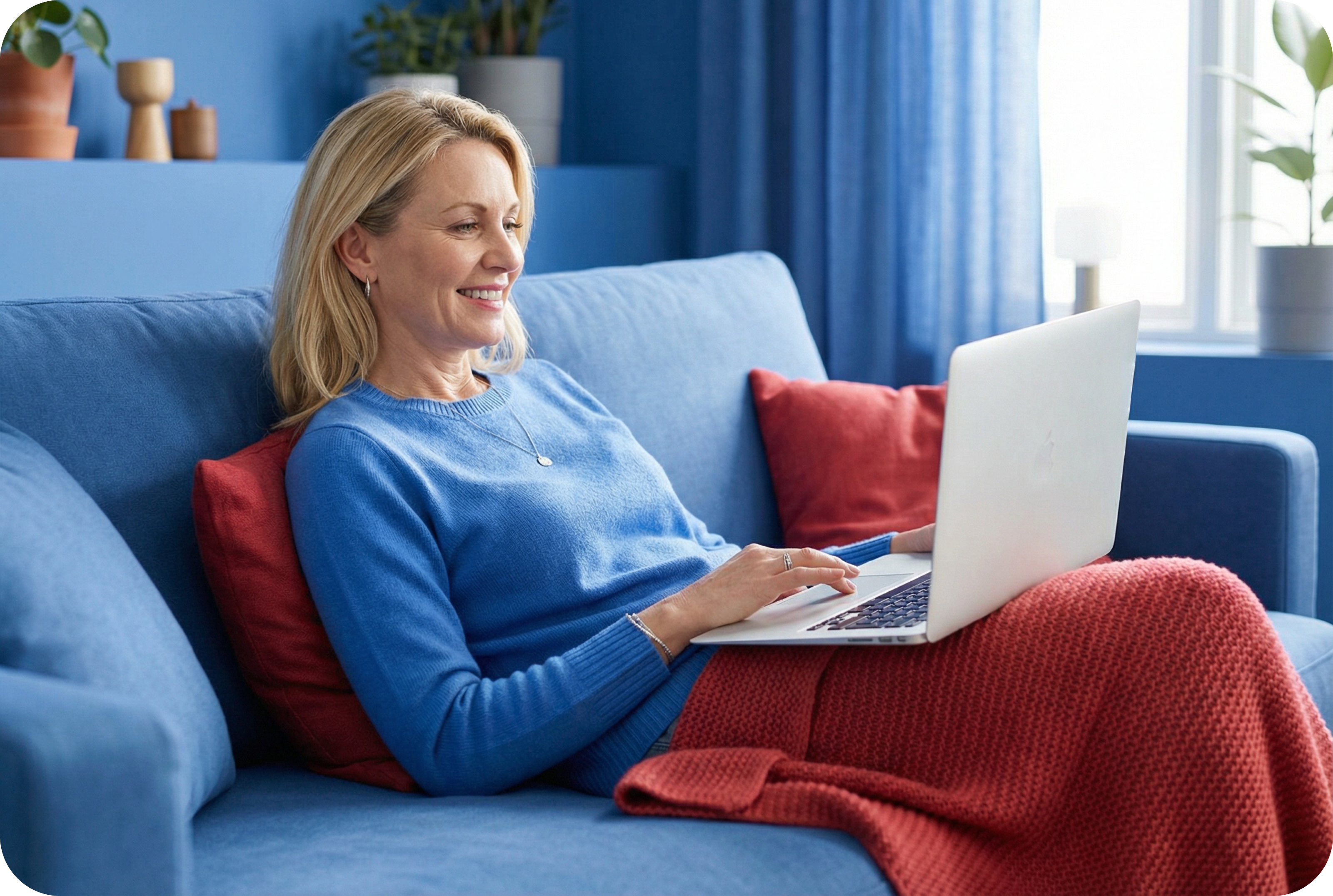 Woman sitting on a couch using a laptop at home