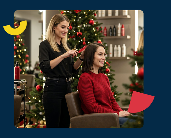 Hairdresser styling a client's hair in a salon decorated for Christmas