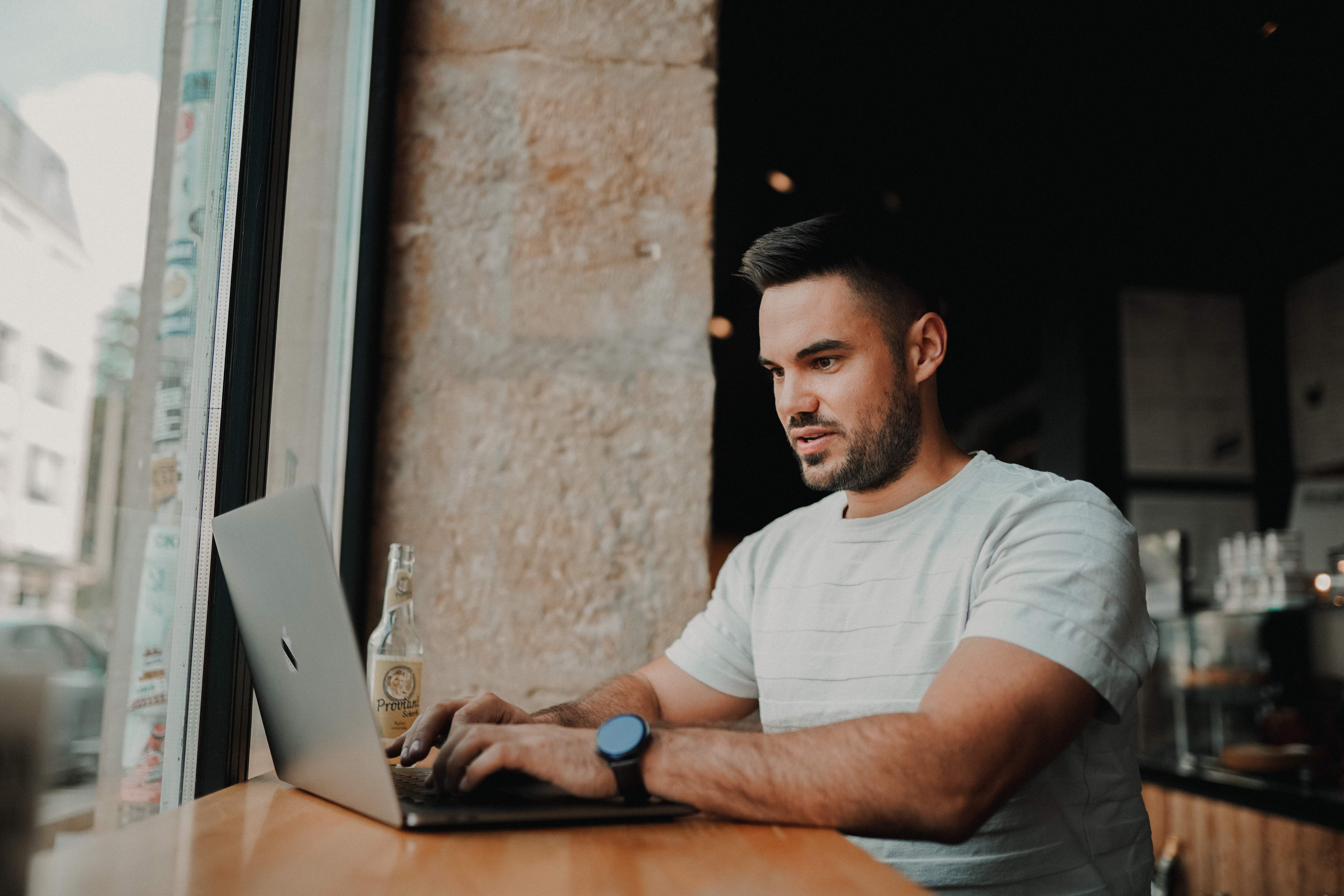 Man sitting in the cafe with laptop