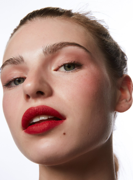Model photographed by Lucy Kinnen wearing bold red lipstick and soft pink blush