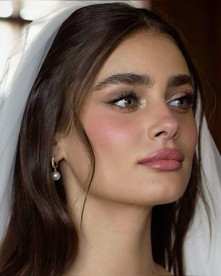 Taylor Hill on her wedding day wearing nude lips and soft pink blush bridal makeup look