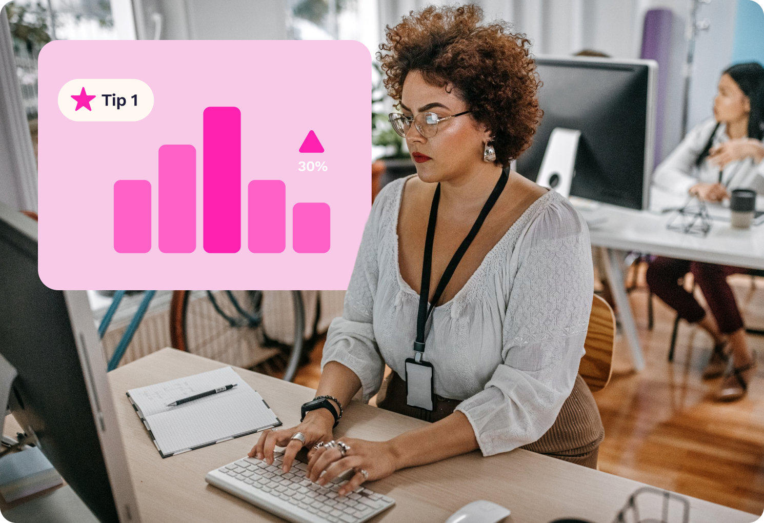 A woman with glasses types at a desk in an office, with a bar graph labeled "Tip 1" and "30%" displayed on her computer screen.